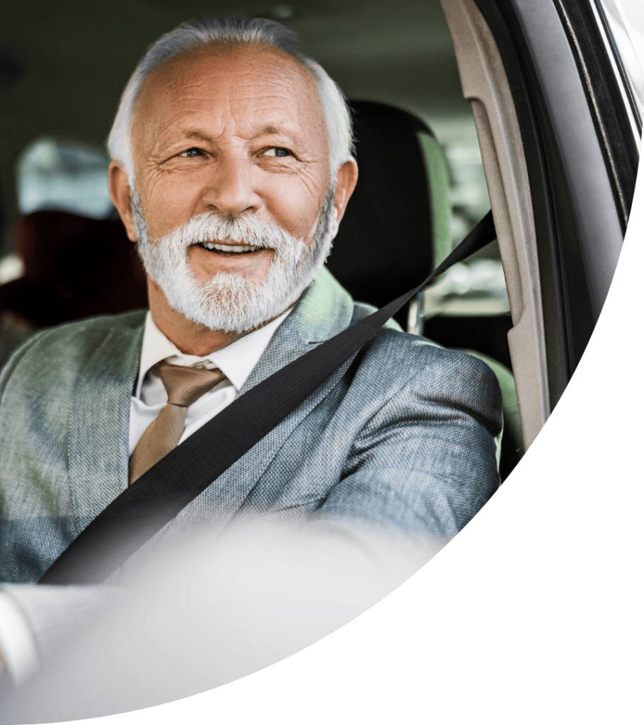 Older Man Smiling out of his car Window